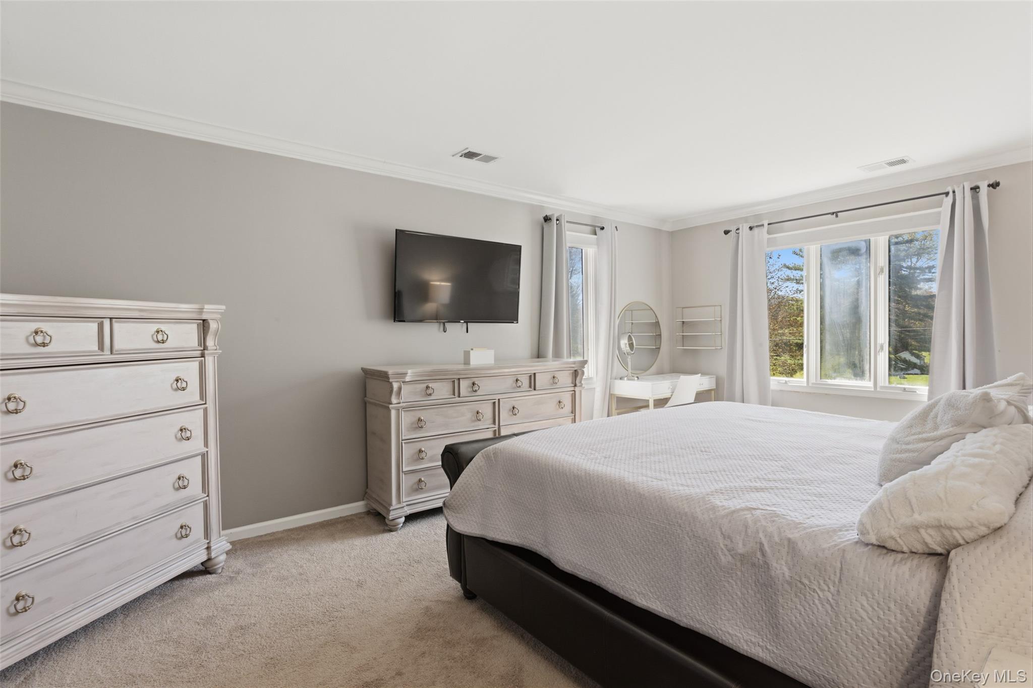 130 Cobb Road Brewster, NY 10509 - Photo 27 of 48 The expansive primary suite offers a walk-in closet, additional linen storage, and a private bath with double vanity and whirlpool tub, along with a separate room that includes both the shower and toilet for added privacy.
