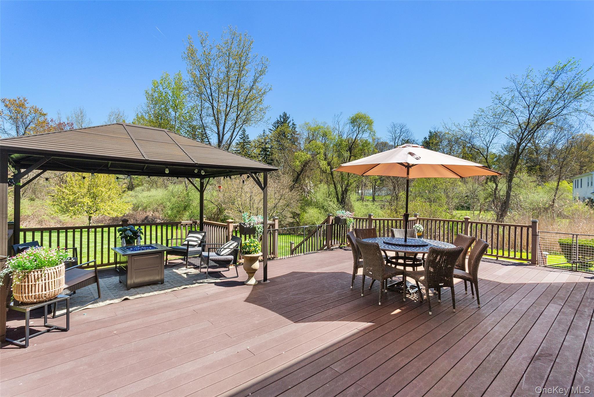 130 Cobb Road Brewster, NY 10509 - Photo 40 of 48 Trex deck overlooking the beautifully level backyard, complete with a pergola for shade—ideal for outdoor dining and relaxing