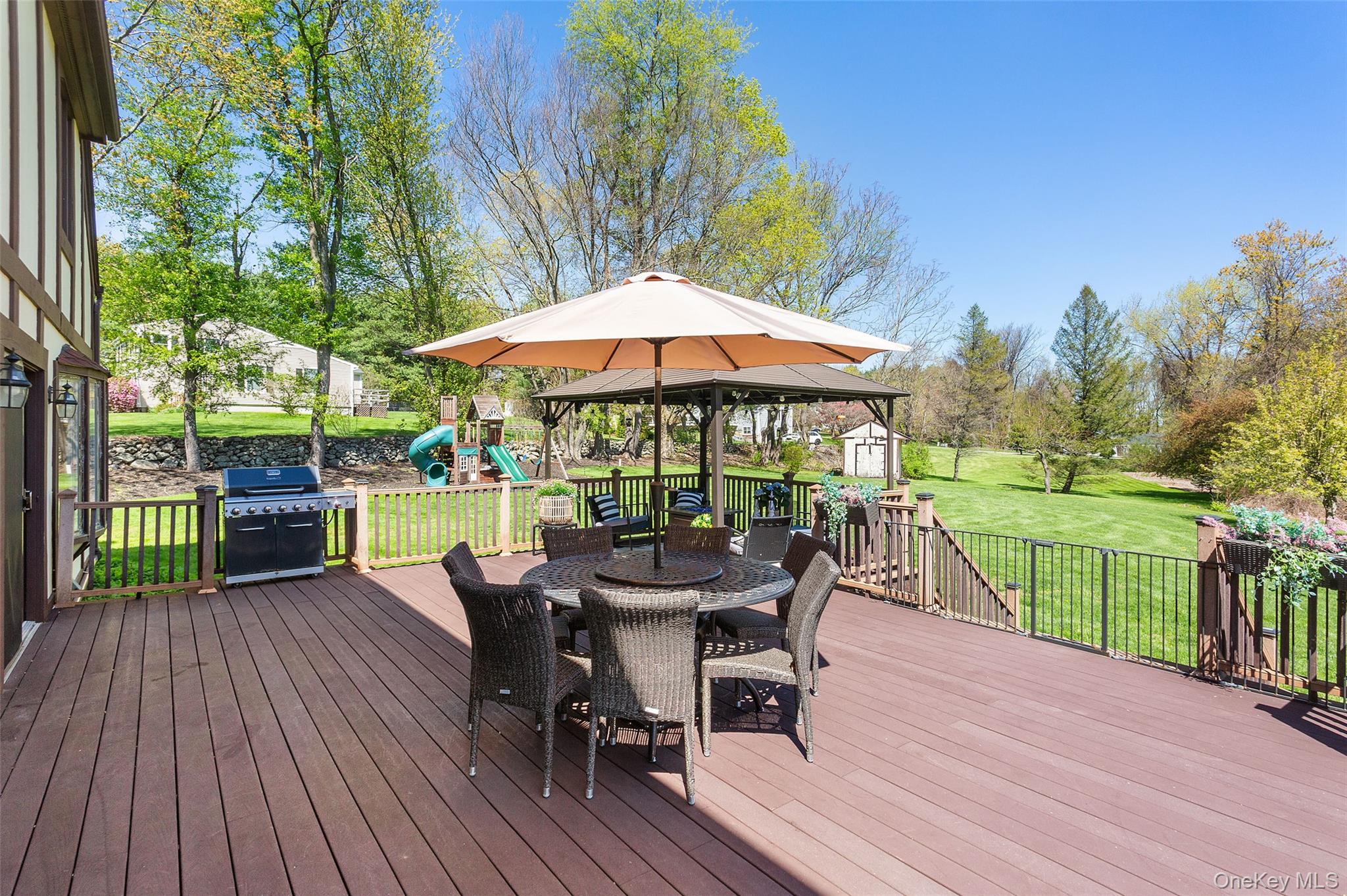 130 Cobb Road Brewster, NY 10509 - Photo 42 of 48 Trex deck overlooking the beautifully level backyard, complete with a pergola for shade—ideal for outdoor dining and relaxing