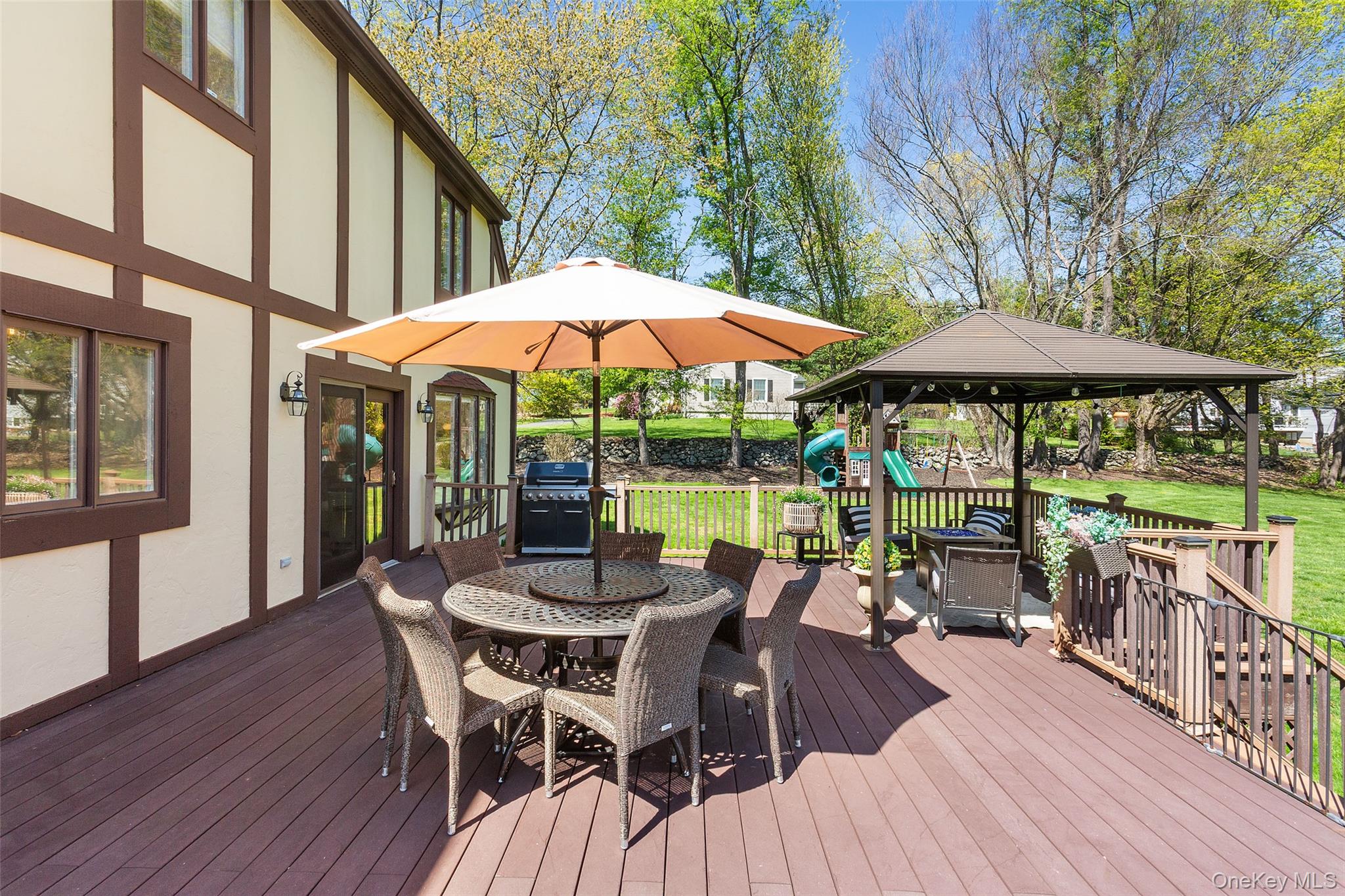 130 Cobb Road Brewster, NY 10509 - Photo 43 of 48 Trex deck overlooking the beautifully level backyard, complete with a pergola for shade—ideal for outdoor dining and relaxing