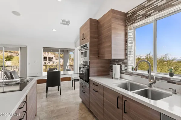 a view of a dining room with furniture and chandelier