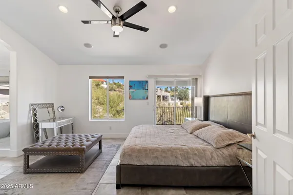 a bedroom with two beds and a large window