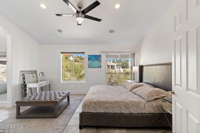 a bedroom with two beds and a large window