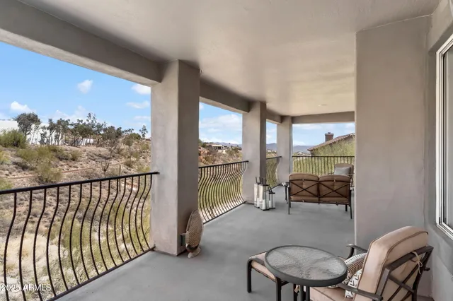 a view of a patio with couches table and chairs with wooden fence