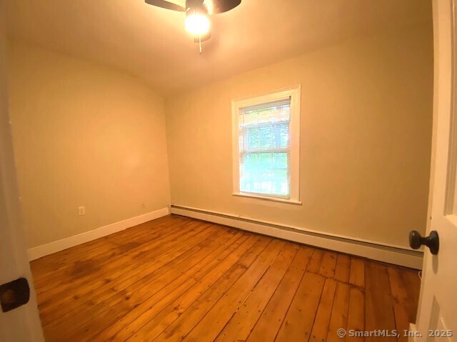 623 Elm Street Monroe, CT 06468 - Photo 14 of 22 a view of an empty room with wooden floor and a window
