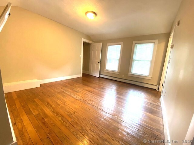 623 Elm Street Monroe, CT 06468 - Photo 16 of 22 an empty room with wooden floor and windows