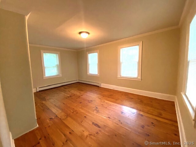 623 Elm Street Monroe, CT 06468 - Photo 20 of 22 an empty room with wooden floor and windows