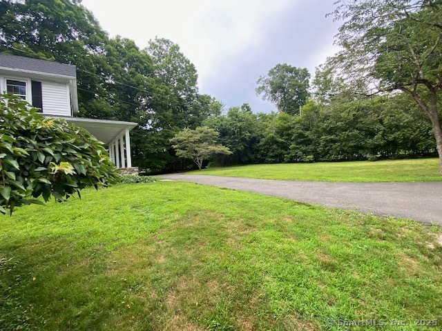 623 Elm Street Monroe, CT 06468 - Photo 3 of 22 a view of a backyard with a small cabin