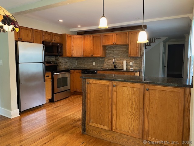 623 Elm Street Monroe, CT 06468 - Photo 6 of 22 a kitchen with stainless steel appliances granite countertop a refrigerator a sink and a stove