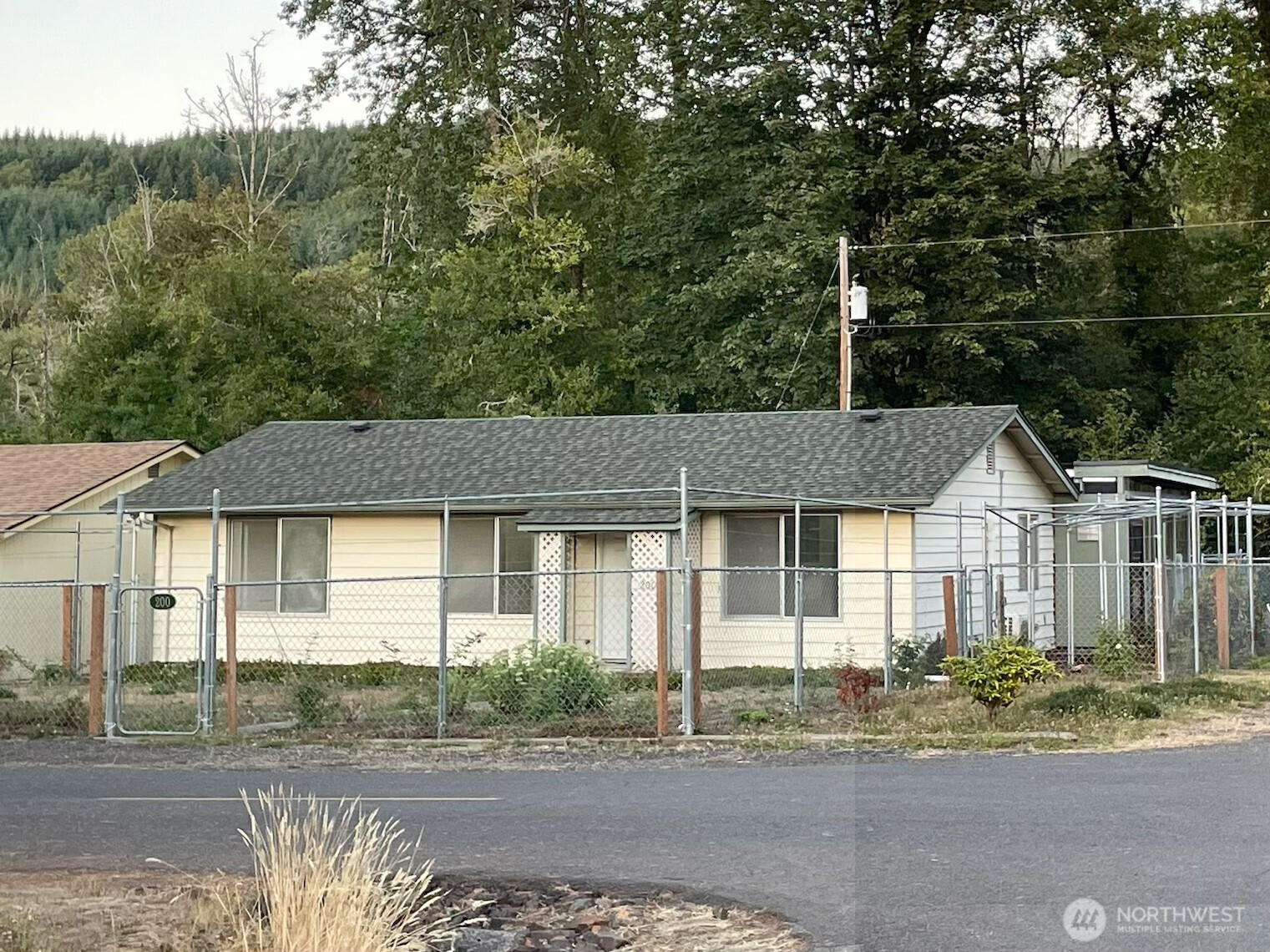 200 Madison Street Ryderwood, WA 98581 - Photo 14 of 26 a front view of a house with a garden and trees
