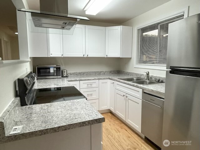 200 Madison Street Ryderwood, WA 98581 - Photo 26 of 26 a kitchen with granite countertop a sink a stove and refrigerator