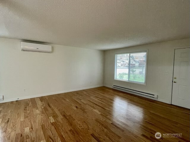 200 Madison Street Ryderwood, WA 98581 - Photo 5 of 26 wooden floor in an empty room with a window