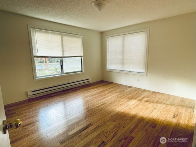 200 Madison Street Ryderwood, WA 98581 - Photo 6 of 26 an empty room with wooden floor and windows