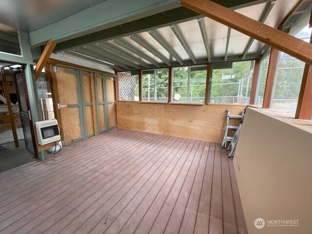 200 Madison Street Ryderwood, WA 98581 - Photo 10 of 26 an empty room with wooden floor and windows