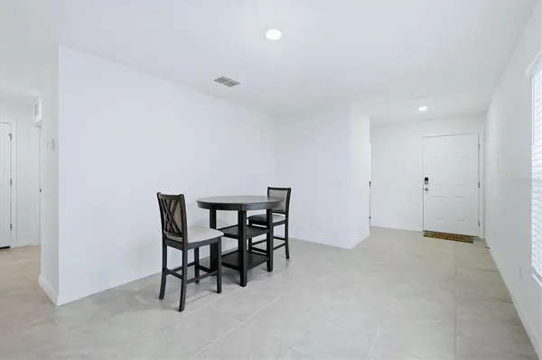a view of a dining room and livingroom with furniture window and wooden floor