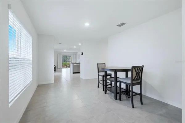 a view of a dining room with furniture and window