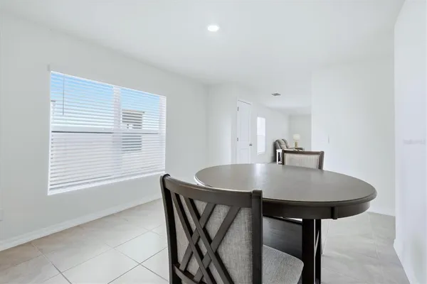 a view of kitchen with kitchen island and stainless steel appliances