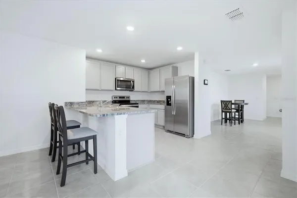 a kitchen with a sink stove and refrigerator