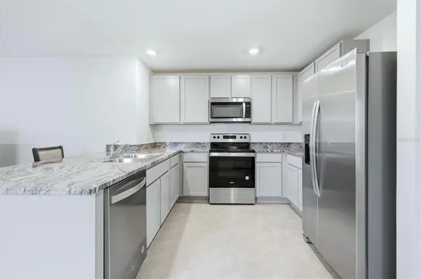 a kitchen with a sink stove and microwave
