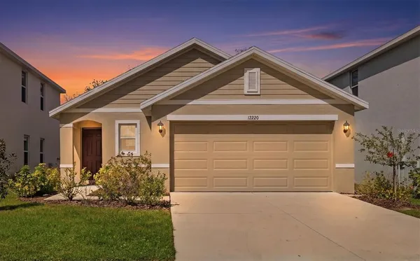 a front view of a house with a yard and garage