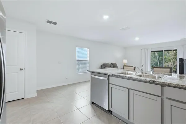 a spacious bedroom with a bed and a window