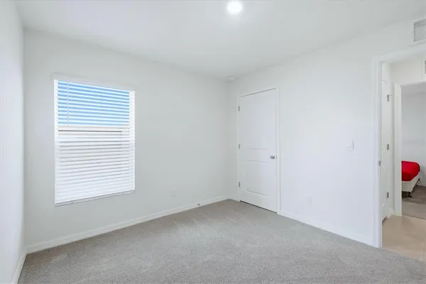 a bathroom with a granite countertop sink and a toilet