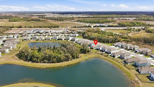 a view of a room with gym equipment and large mirror