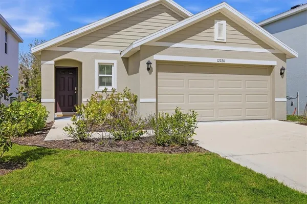 a front view of a house with a garden