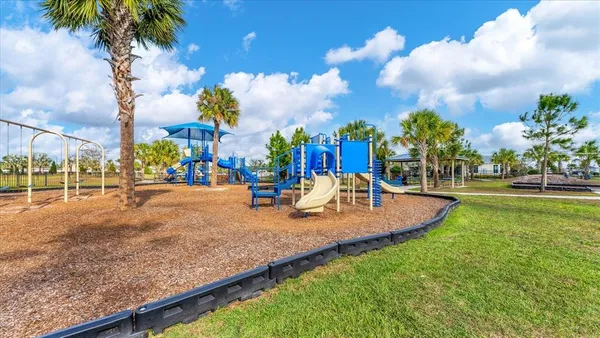 a view of outdoor space with playground and green space