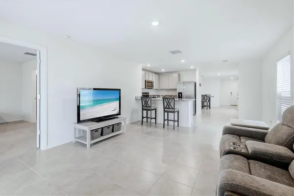a view of kitchen with furniture and a flat screen tv