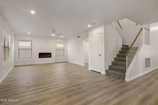 a view of empty room with wooden floor