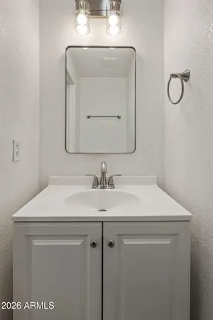 a bathroom with a sink vanity and a mirror