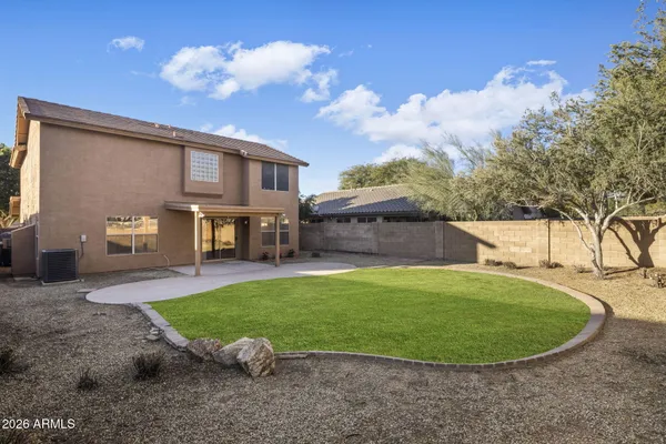 a view of a house with a backyard