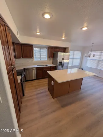 a large kitchen with stainless steel appliances kitchen island a large counter top and a sink
