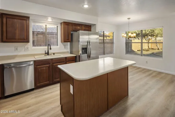 a kitchen with a stove a sink a refrigerator and a oven