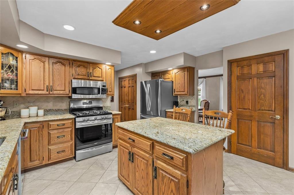 156 Revo Road Pittsburgh, PA 15236 - Photo 9 of 28 Stainless appliances...pantry...convenient main floor laundry! The island breakfast bar design will be great for after school snacks and a chat!