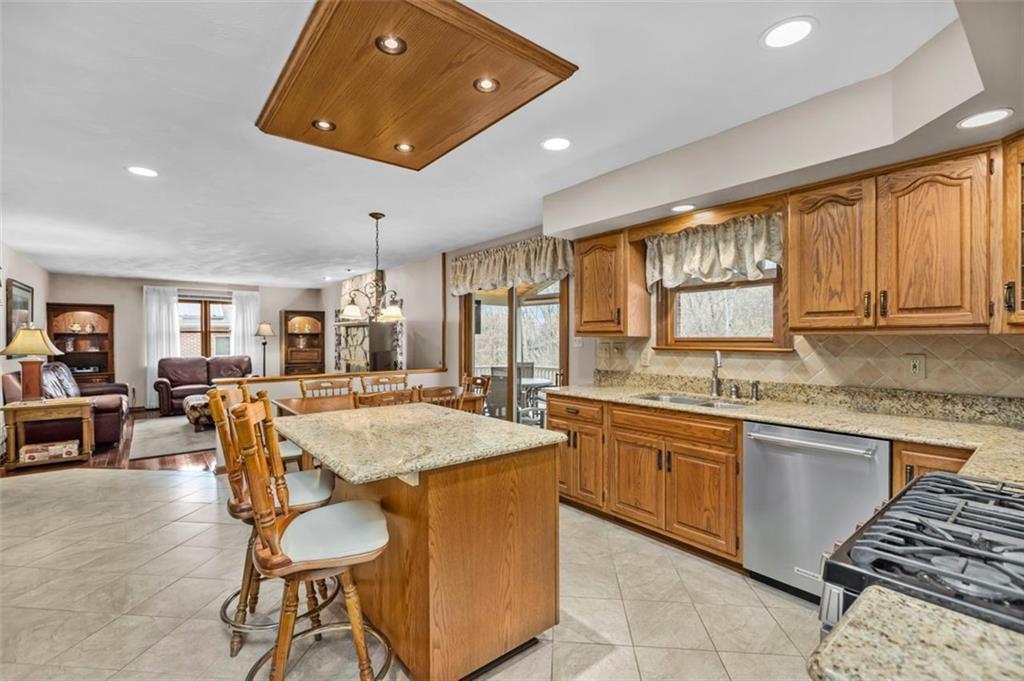 156 Revo Road Pittsburgh, PA 15236 - Photo 10 of 28 A cook's delight! The center island kitchen offers an abundance of cabinet and granite counter top space! A dining area and access to the deck are provided.