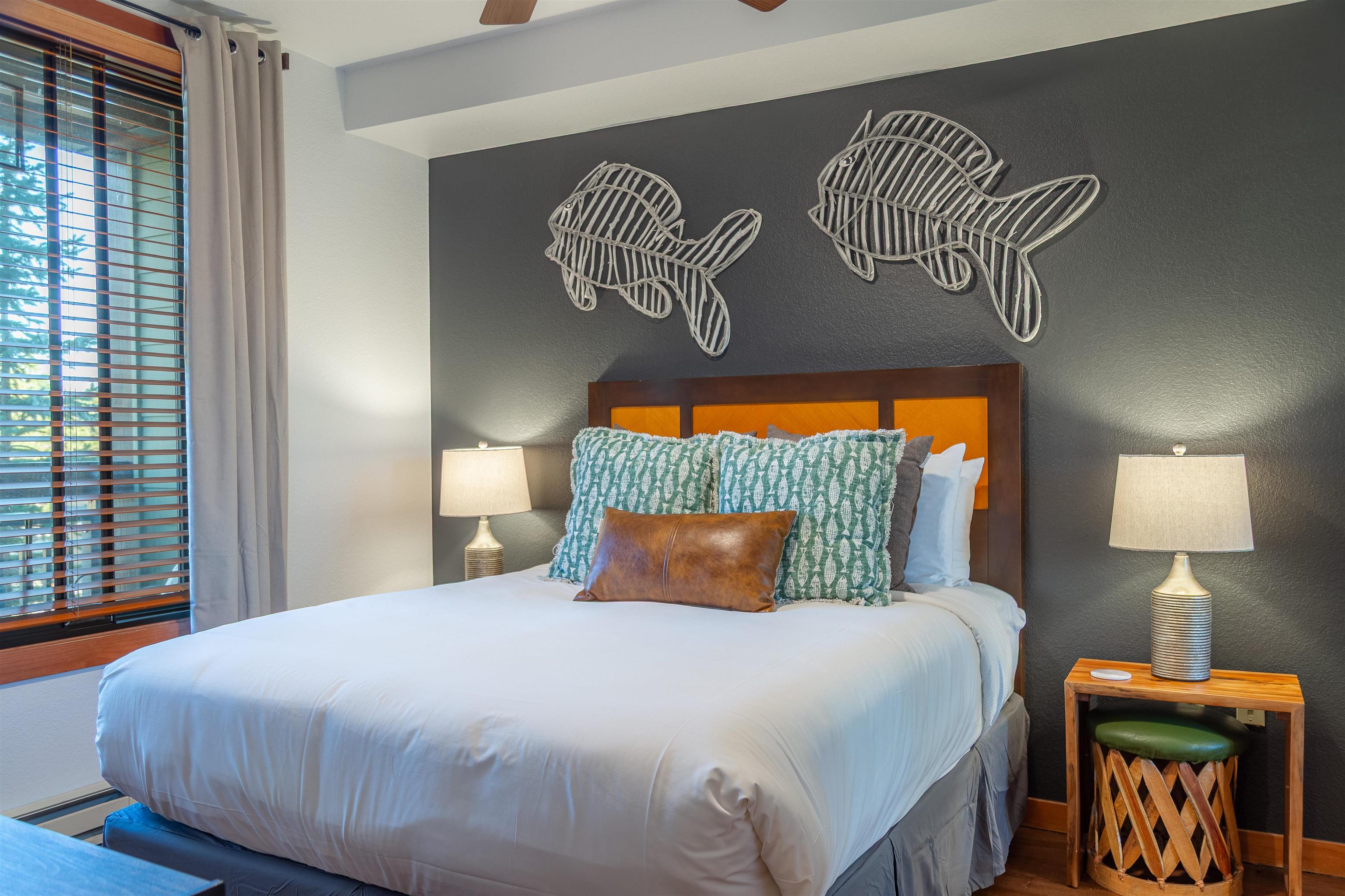 6201 Minaret Road, Unit 2221 Mammoth Lakes, CA 93546 - Photo 23 of 44 Bedroom featuring a dark accent wall, wood-finish flooring, a wood headboard with orange paneling, and a window with horizontal blinds and drapes