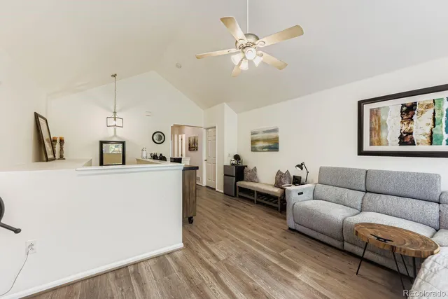 a living room with furniture and a wooden floor