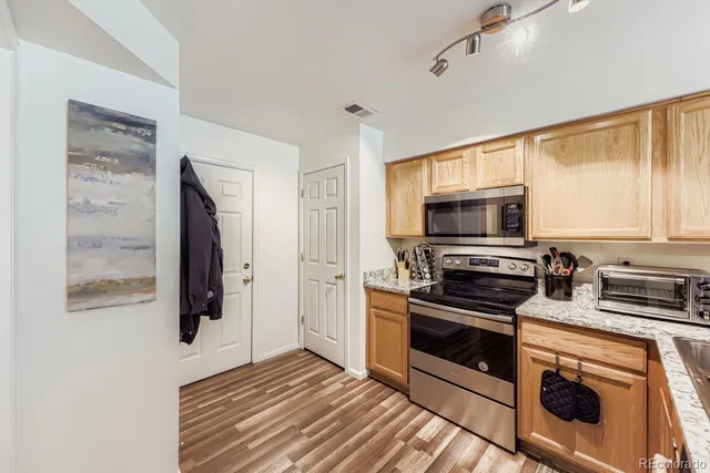 a kitchen with stainless steel appliances a stove a microwave and a refrigerator