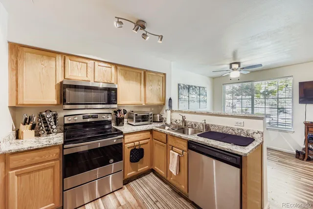 a kitchen with stainless steel appliances a stove sink microwave and cabinets