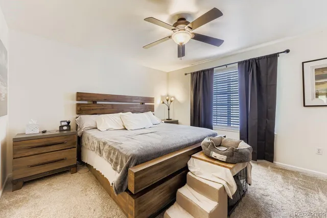 a bedroom with a bed and a ceiling fan