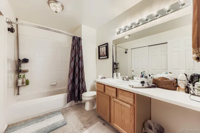a bathroom with a tub sink toilet and mirror
