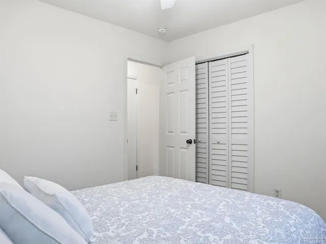 a bedroom with a bed and a night stand