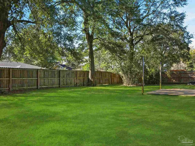 a view of a backyard with a garden and entertaining space