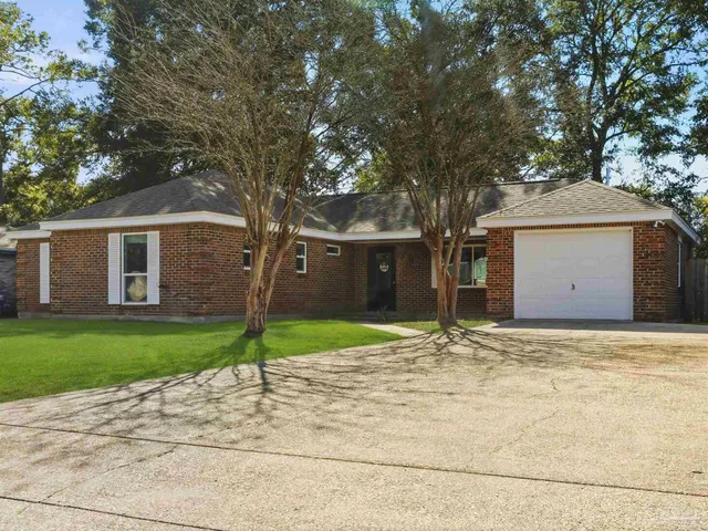 a house with tree in front of it