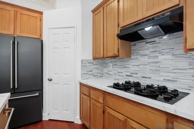 a kitchen with a stove and a refrigerator