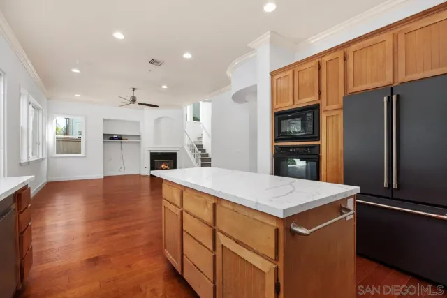a kitchen with a refrigerator and a stove top oven
