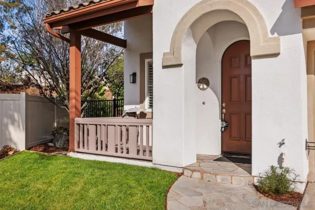 a view of a porch with furniture and garden
