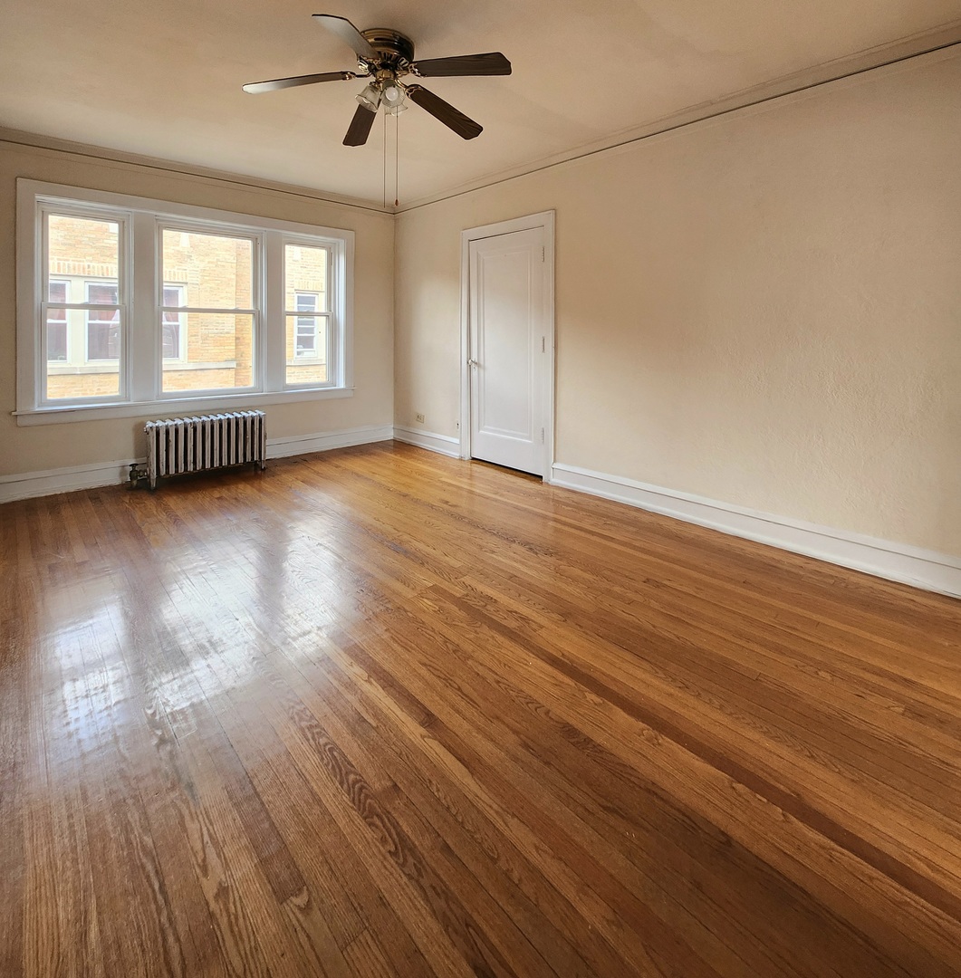 5423 West Montrose Avenue, Unit N3 Chicago, IL 60641 - Photo 2 of 10 wooden floor in an empty room with a window
